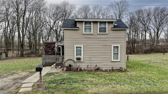 rear view of house with a yard