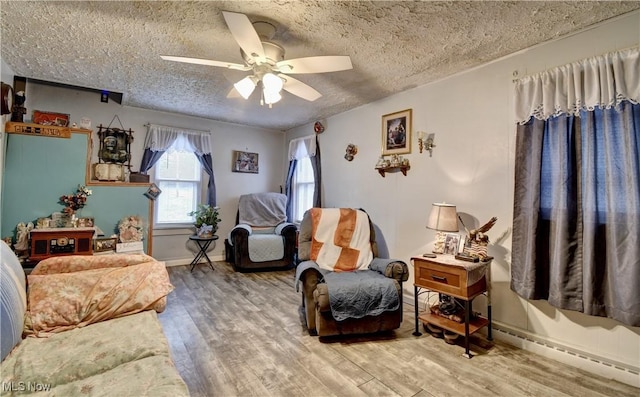 interior space featuring hardwood / wood-style flooring, ceiling fan, and a textured ceiling