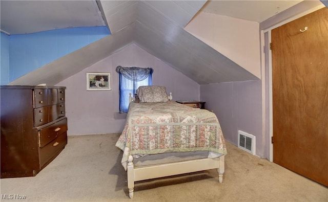 bedroom with light colored carpet and vaulted ceiling