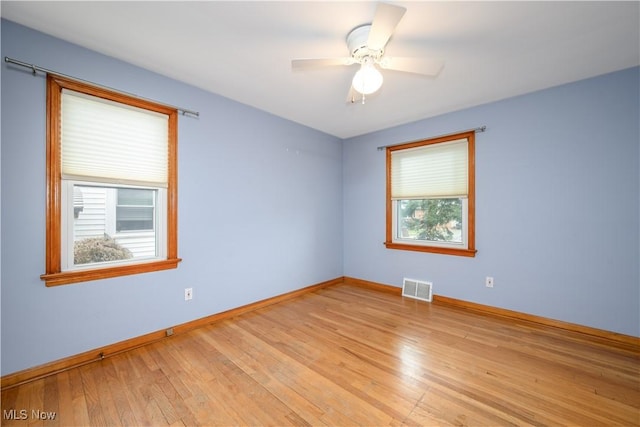 unfurnished room featuring ceiling fan, a healthy amount of sunlight, and light hardwood / wood-style floors