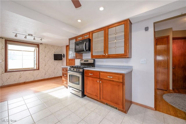 kitchen with rail lighting, gas stove, and light wood-type flooring