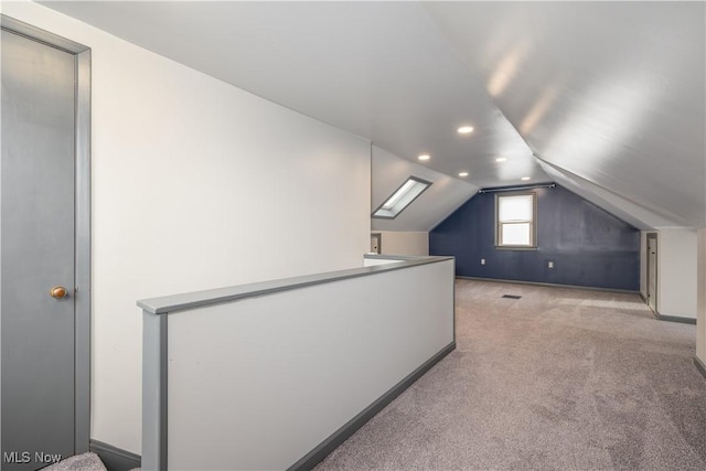 bonus room featuring vaulted ceiling and light colored carpet