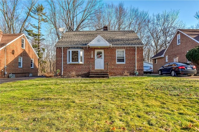 bungalow-style home featuring a front lawn