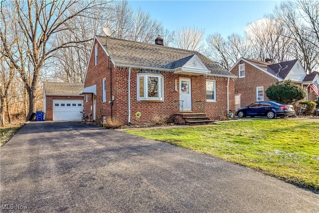 view of front of property featuring a garage and a front lawn