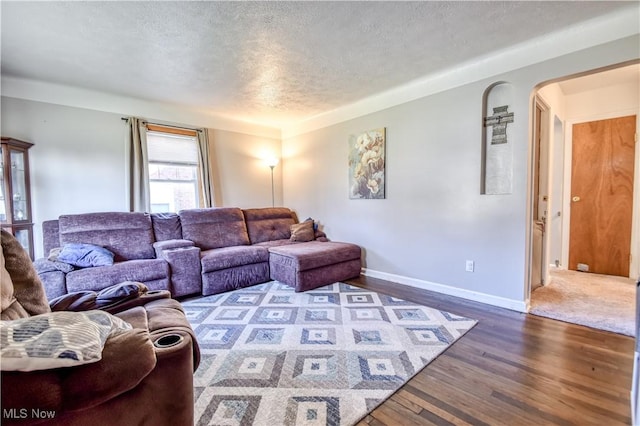 living room with hardwood / wood-style flooring and a textured ceiling