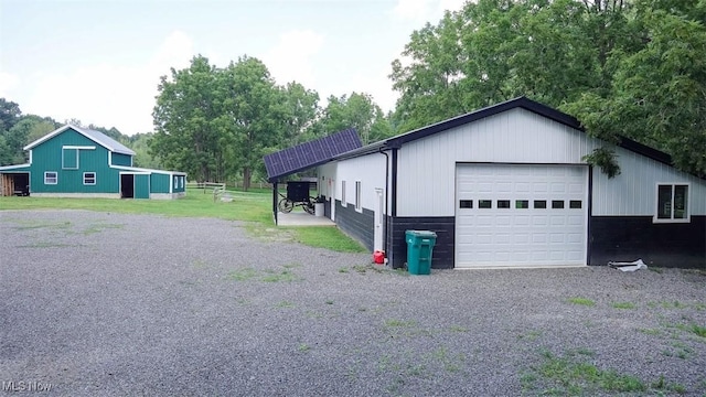 exterior space featuring an outbuilding and a garage