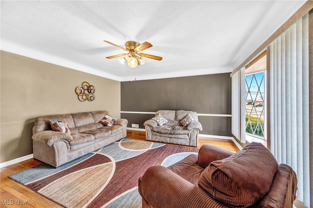 living room with hardwood / wood-style flooring and ceiling fan