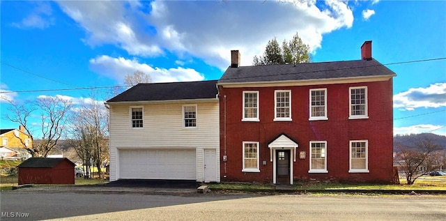 colonial inspired home with a garage