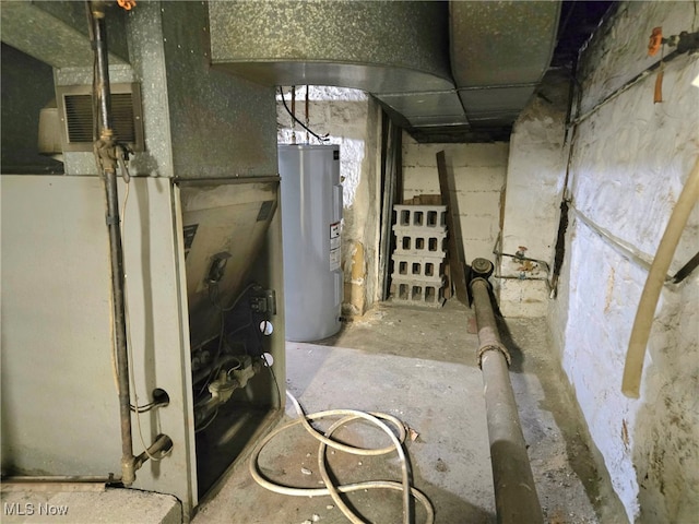 utility room with heating unit and electric water heater