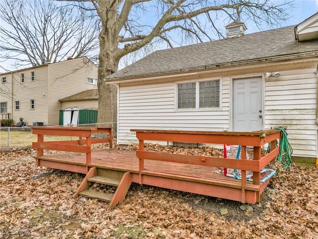 rear view of property with a wooden deck