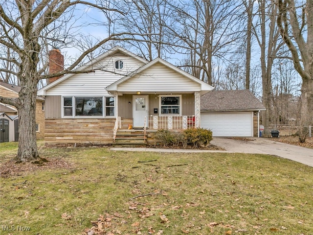 view of front of house featuring a garage, a front yard, and covered porch