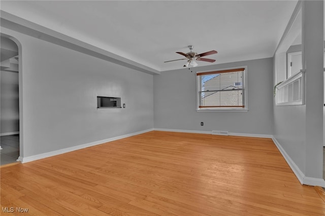 unfurnished room with ceiling fan and light wood-type flooring