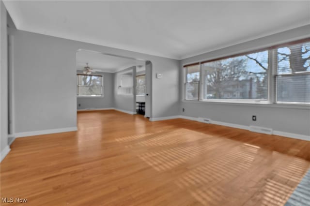 unfurnished living room featuring ceiling fan and light wood-type flooring