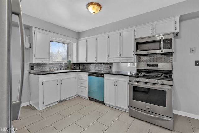 kitchen featuring sink, decorative backsplash, stainless steel appliances, and white cabinets