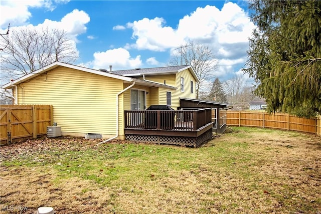 rear view of house with a yard, a wooden deck, and central air condition unit