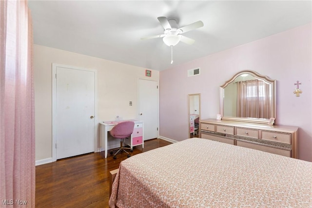 bedroom with ceiling fan and dark hardwood / wood-style floors