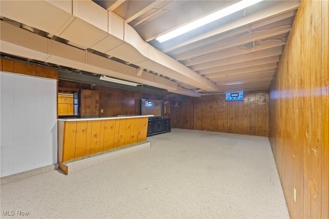 basement with bar and wood walls