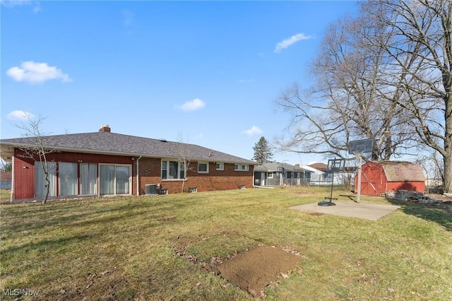 view of yard featuring a storage shed, central AC, and a patio