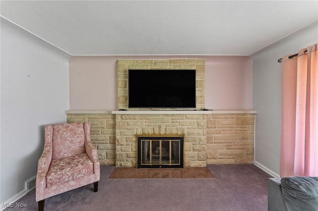 living room featuring a fireplace and carpet