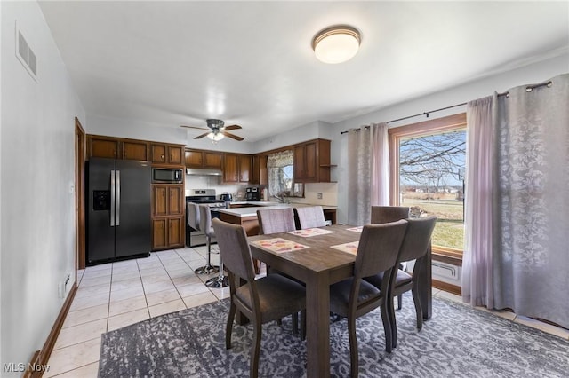 dining room with light tile patterned floors and ceiling fan