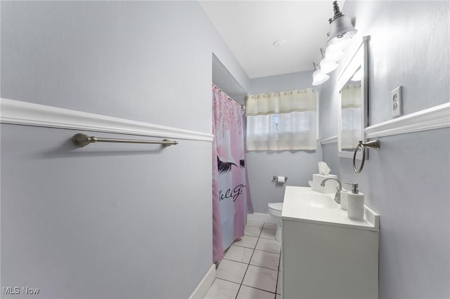 bathroom with vanity, toilet, and tile patterned flooring