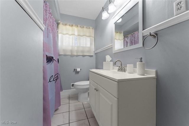 bathroom featuring vanity, tile patterned flooring, and toilet