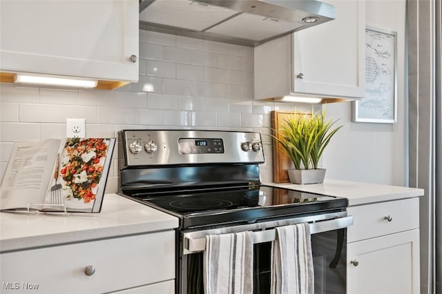 kitchen featuring white cabinetry, ventilation hood, stainless steel range with electric cooktop, and tasteful backsplash