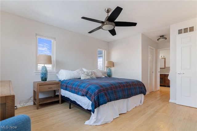 bedroom featuring multiple windows, light hardwood / wood-style floors, and ceiling fan