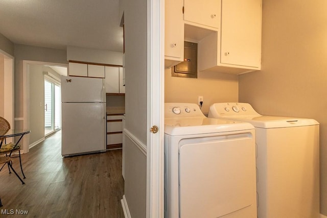 laundry area with cabinets, dark wood-type flooring, and washer and dryer