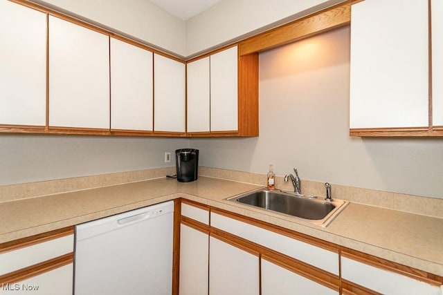 kitchen featuring white cabinetry, white dishwasher, and sink