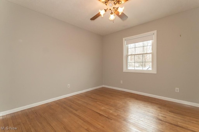 spare room featuring wood-type flooring and ceiling fan