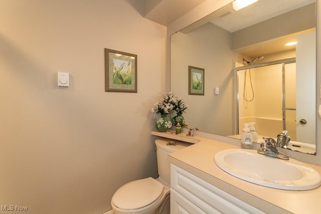 bathroom featuring an enclosed shower, vanity, and toilet