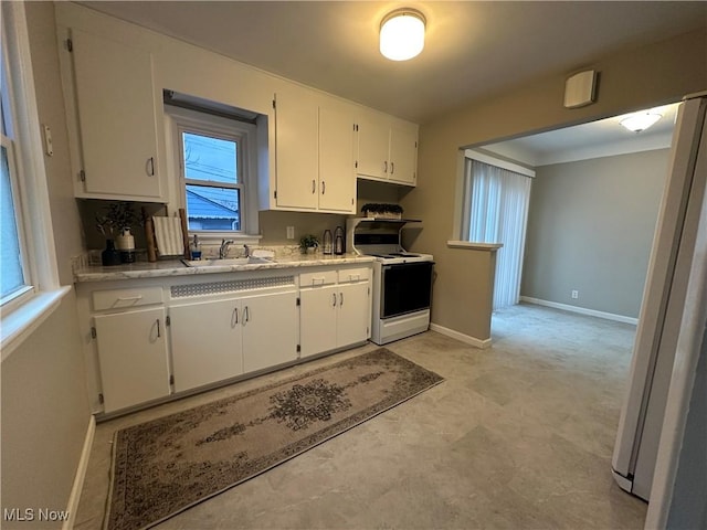 kitchen featuring white cabinetry, white appliances, and sink