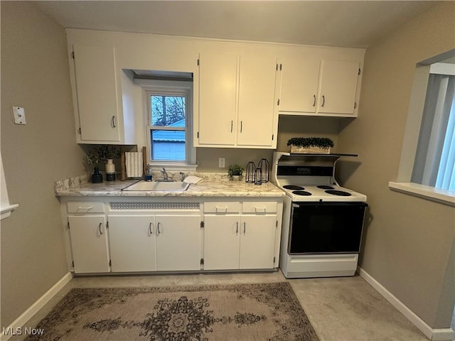 kitchen featuring range with electric cooktop, sink, and white cabinets