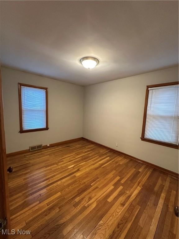 spare room with hardwood / wood-style floors