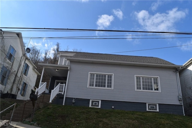 view of side of home with a lawn