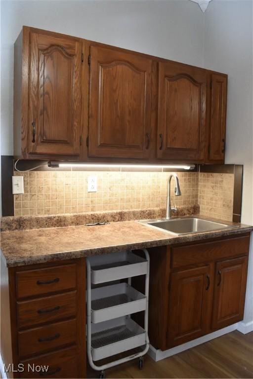 kitchen featuring sink, backsplash, beverage cooler, and dark hardwood / wood-style floors