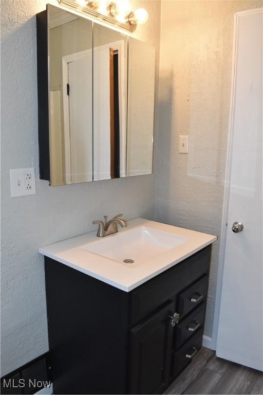 bathroom with vanity and hardwood / wood-style floors