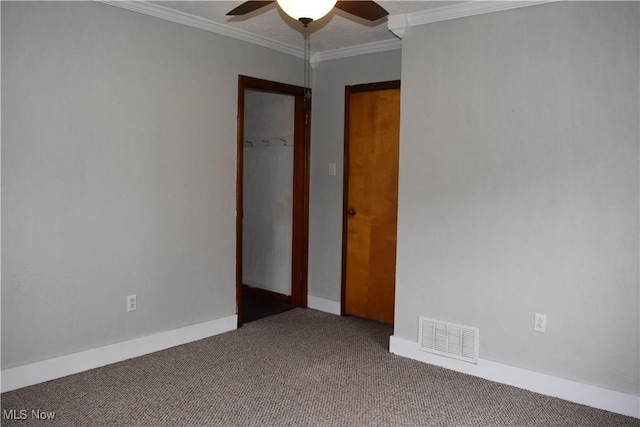 unfurnished room with crown molding, ceiling fan, and carpet flooring