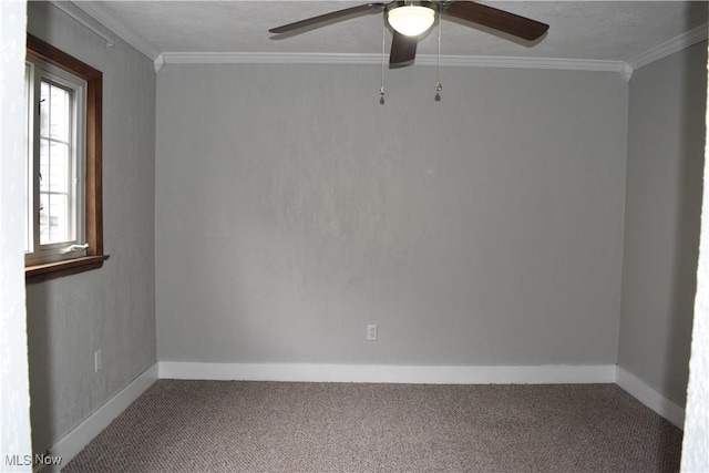 carpeted spare room featuring ornamental molding and ceiling fan