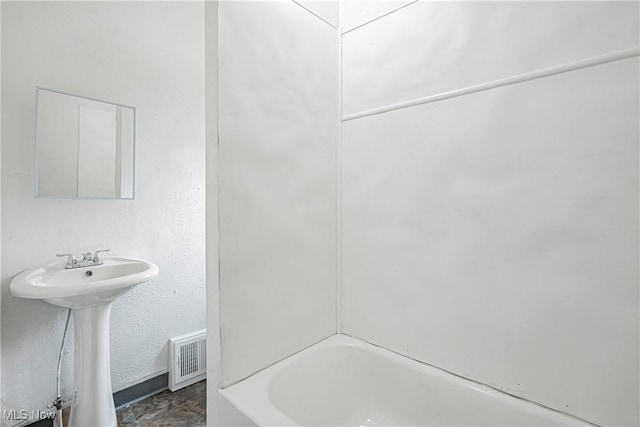 bathroom featuring sink and a tub