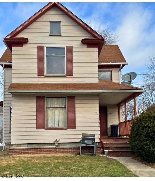 rear view of property with a lawn