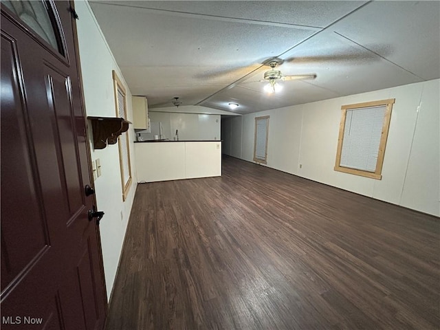 interior space with wood-type flooring, ceiling fan, and vaulted ceiling