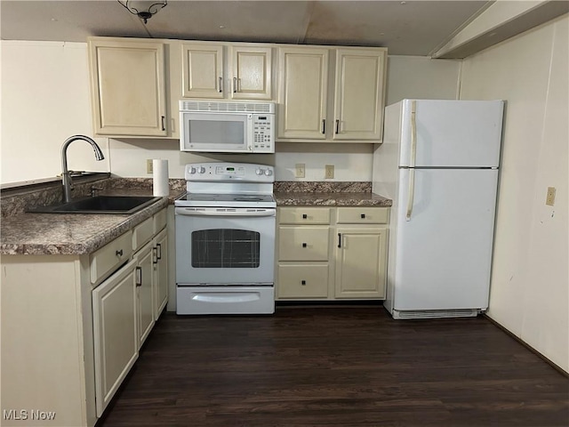 kitchen featuring dark hardwood / wood-style flooring, sink, white appliances, and cream cabinets