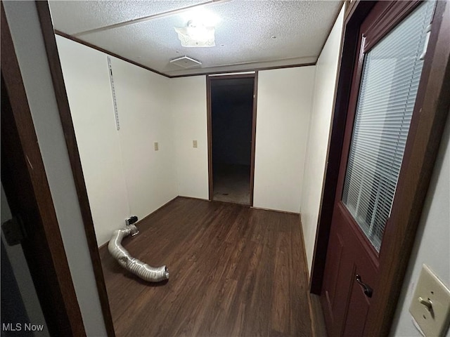 interior space featuring dark wood-type flooring and a textured ceiling