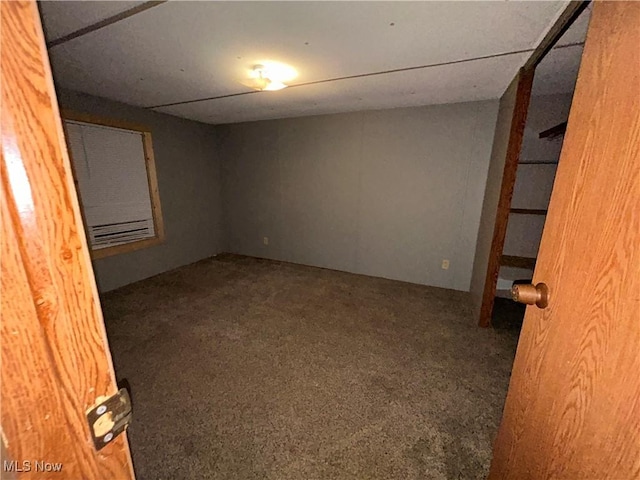 empty room featuring dark colored carpet