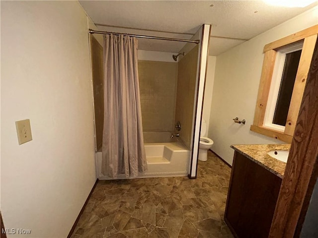 full bathroom with vanity, shower / tub combo, and toilet