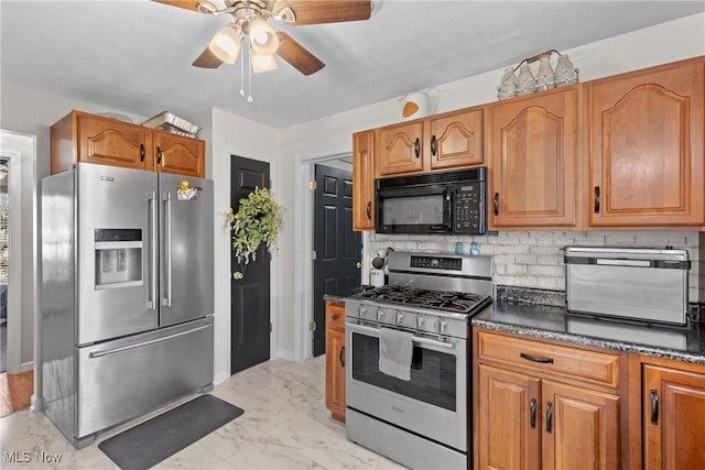 kitchen with appliances with stainless steel finishes, backsplash, and ceiling fan