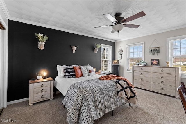 carpeted bedroom featuring crown molding and ceiling fan