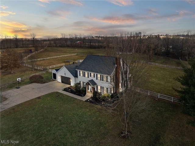 aerial view at dusk featuring a rural view